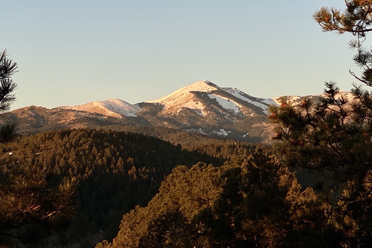 Sierra Blanca at first light, seen from a cabin porch in Alto, New Mexico